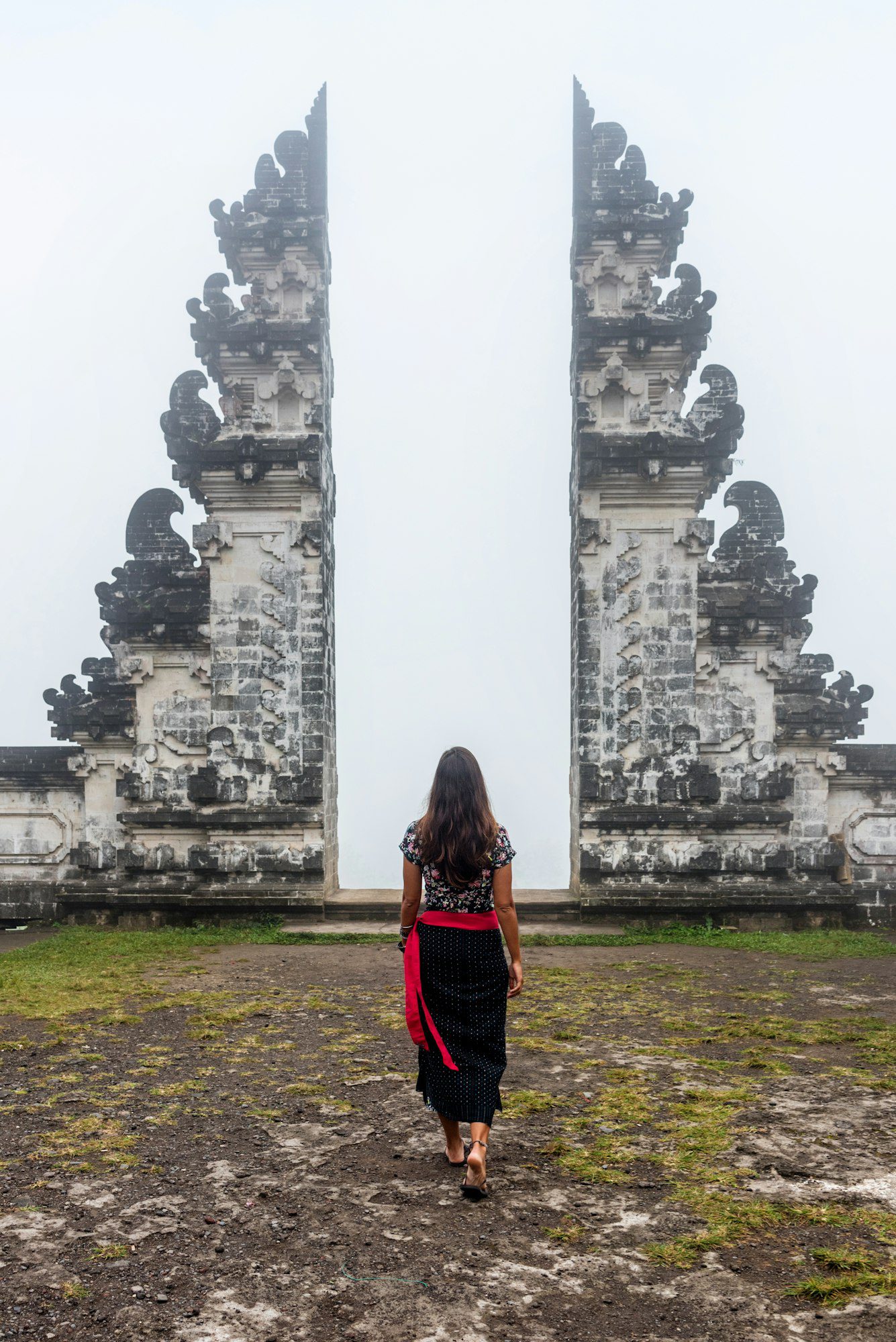 Woman in front of Traditional Balinese gate, Indonesia